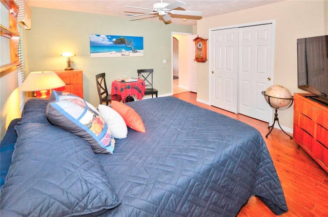 bedroom featuring a closet, ceiling fan, and wood-type flooring