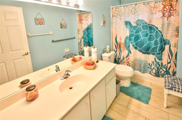 bathroom featuring tile patterned floors, vanity, and toilet