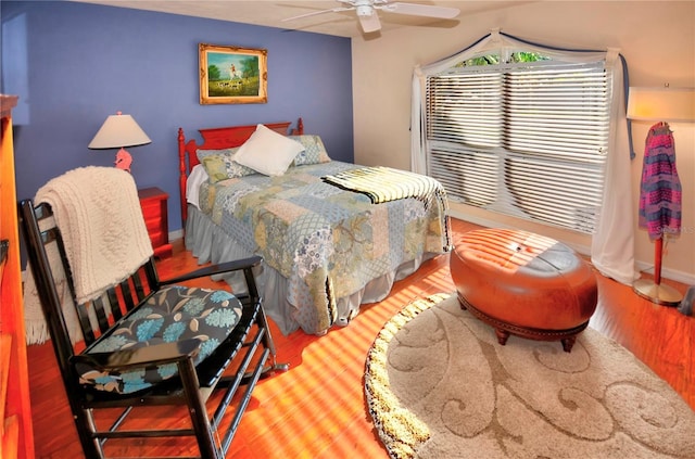 bedroom with hardwood / wood-style floors and ceiling fan