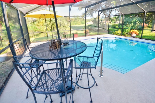 view of swimming pool with a lanai and a patio area