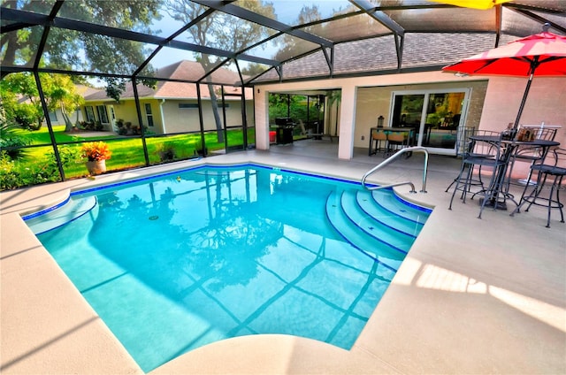 view of swimming pool featuring a lawn, glass enclosure, and a patio area