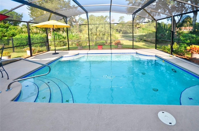 view of pool featuring glass enclosure and a patio