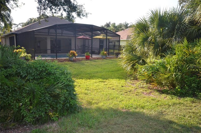 view of yard with glass enclosure