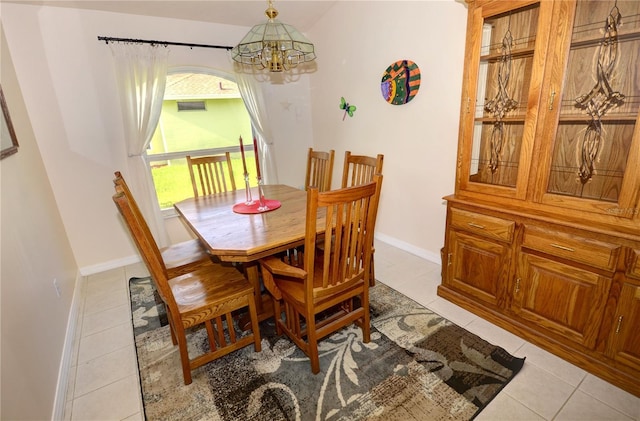 dining room featuring an inviting chandelier and light tile patterned floors