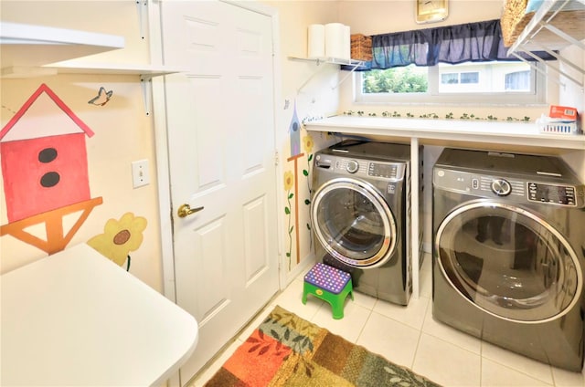 laundry room with washing machine and clothes dryer and light tile patterned flooring