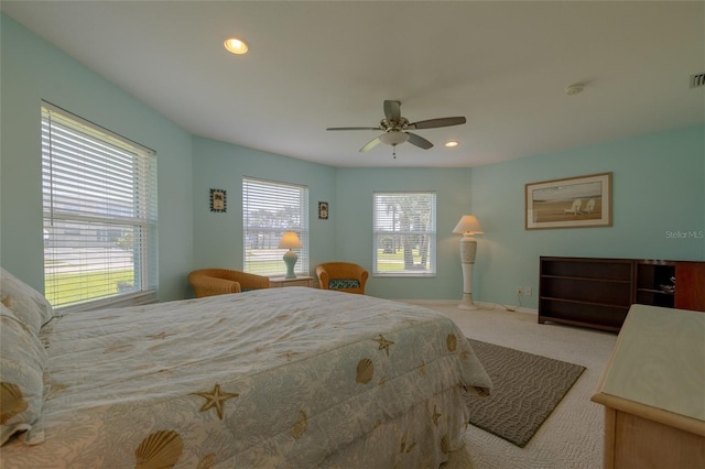 carpeted bedroom featuring recessed lighting, visible vents, ceiling fan, and baseboards