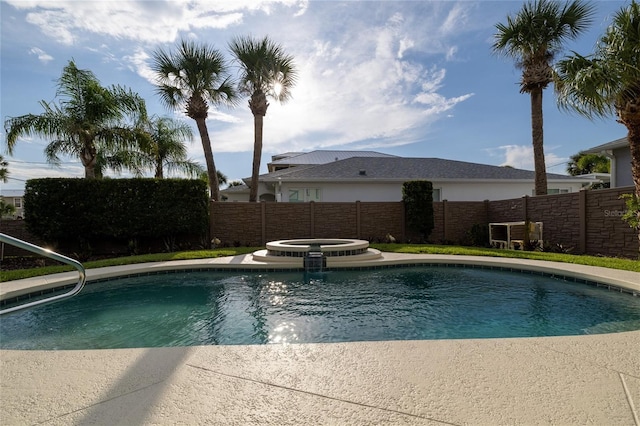 view of pool with a pool with connected hot tub and fence