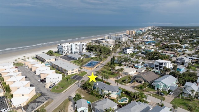 birds eye view of property featuring a water view and a view of the beach