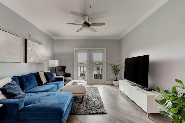 living room featuring ceiling fan, french doors, crown molding, and light wood-type flooring