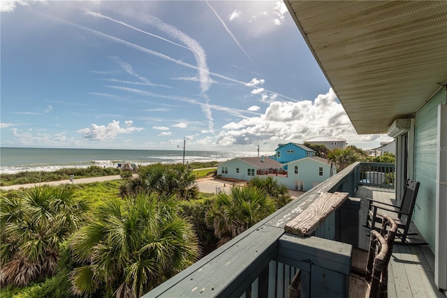 balcony featuring a water view and a beach view