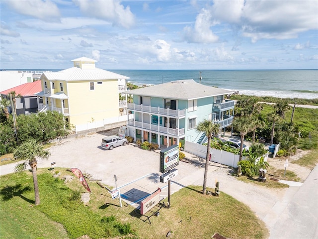 drone / aerial view featuring a water view and a beach view