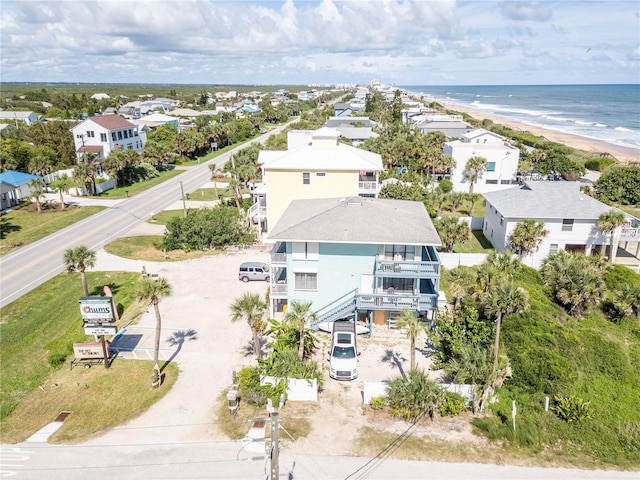 bird's eye view featuring a view of the beach and a water view