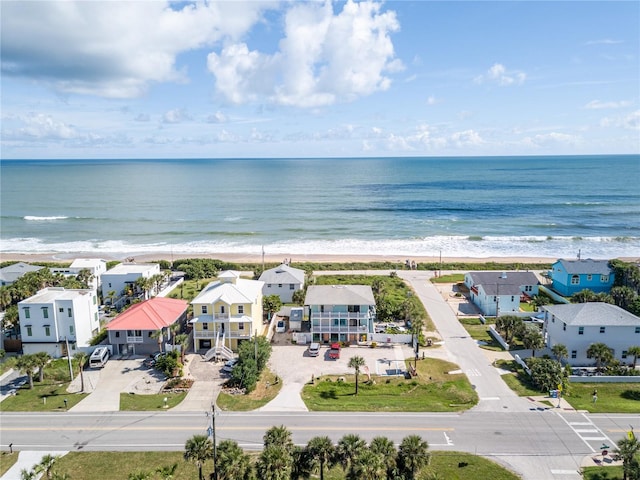 birds eye view of property featuring a view of the beach and a water view