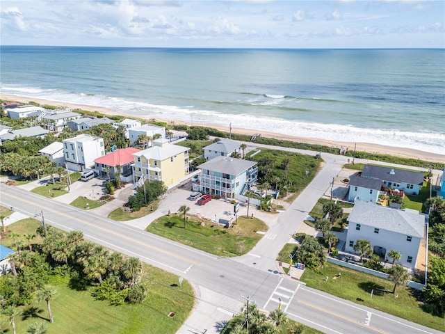 birds eye view of property with a water view and a view of the beach