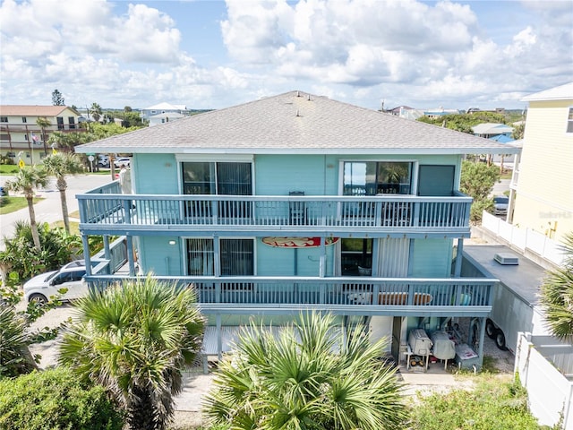 back of house featuring a patio and a balcony