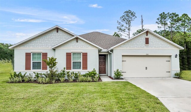 view of front of property featuring a garage and a front lawn