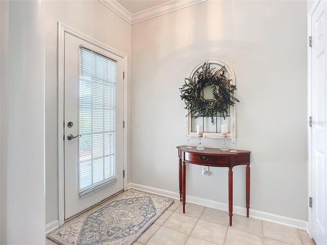 doorway featuring light tile patterned floors, crown molding, and a healthy amount of sunlight