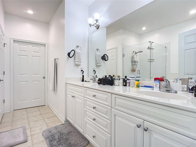 bathroom with double sink vanity, walk in shower, and tile patterned flooring