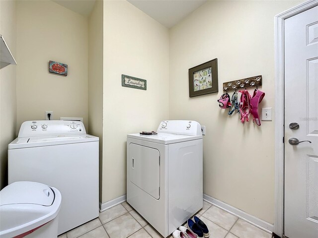 laundry room with light tile patterned flooring and washer and dryer