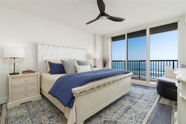 bedroom featuring access to exterior, expansive windows, wood finished floors, baseboards, and ceiling fan