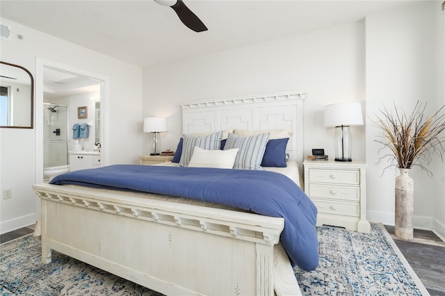 bedroom featuring visible vents, connected bathroom, baseboards, wood finished floors, and a ceiling fan