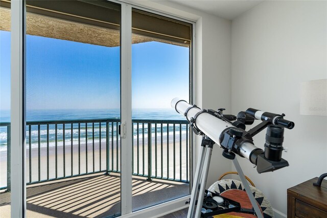 interior space with a beach view and a water view