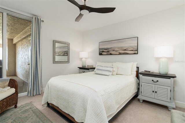 bedroom with baseboards, light carpet, and ceiling fan