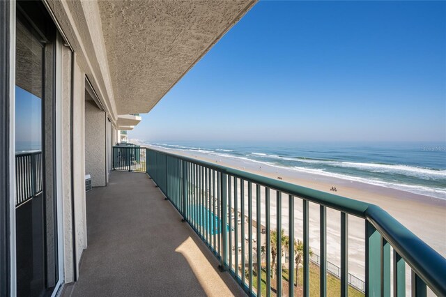 balcony with a view of the beach and a water view