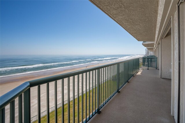 balcony with a view of the beach and a water view