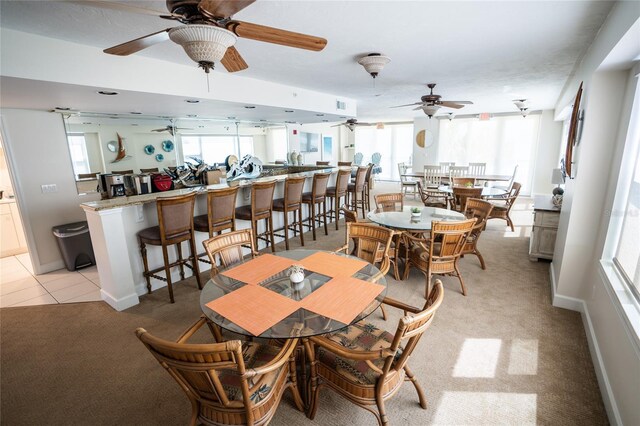 dining space featuring visible vents, light carpet, baseboards, and light tile patterned flooring