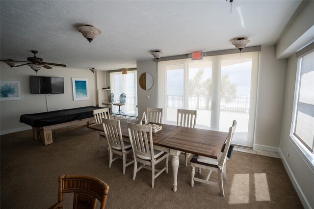 carpeted dining room featuring pool table and baseboards