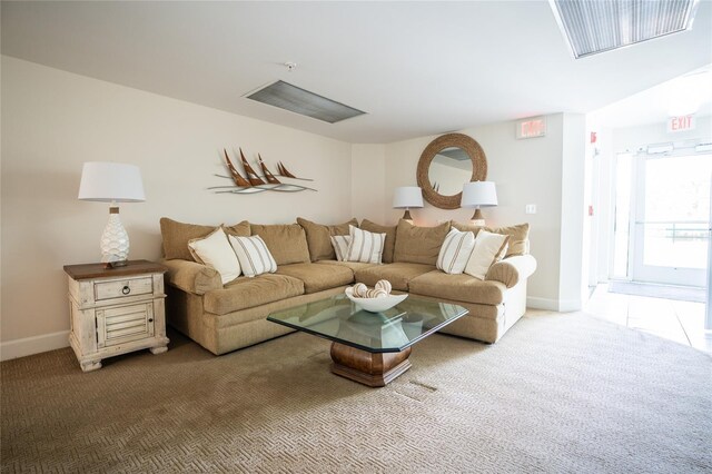 living room featuring carpet flooring and baseboards