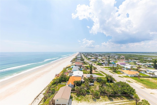 birds eye view of property with a water view and a view of the beach