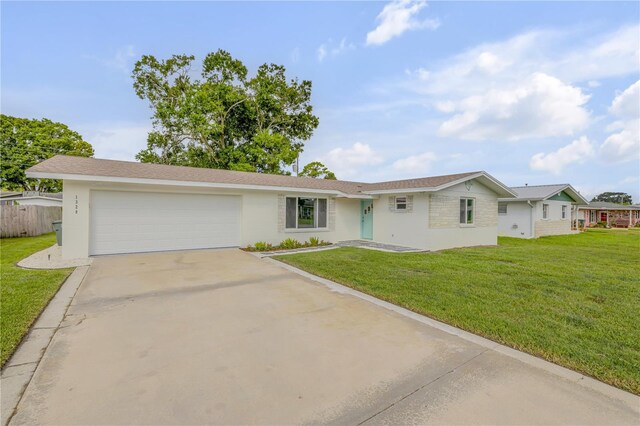 single story home with a front yard and a garage