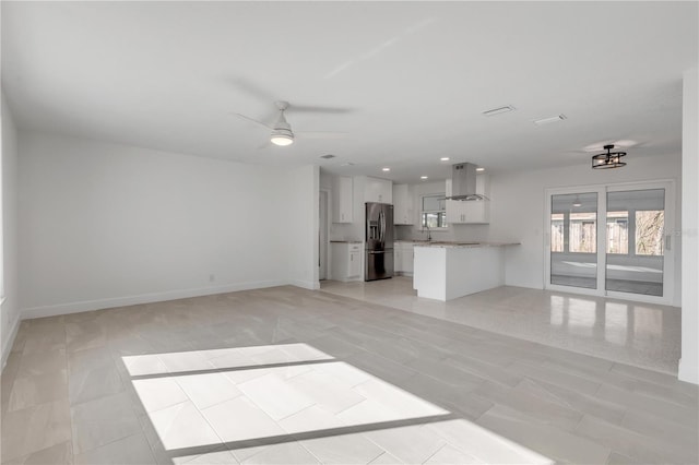 unfurnished living room with ceiling fan and light tile patterned floors