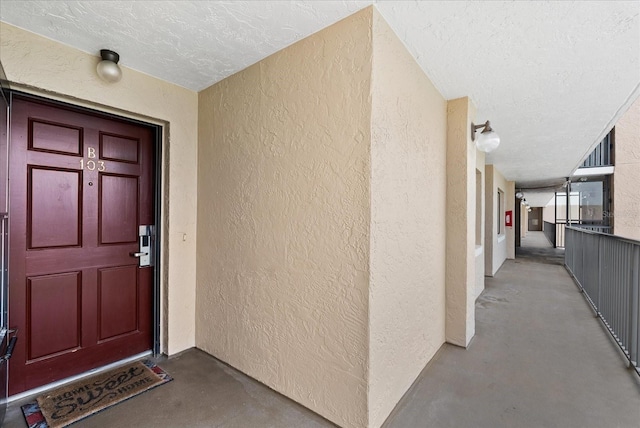 doorway to property featuring stucco siding