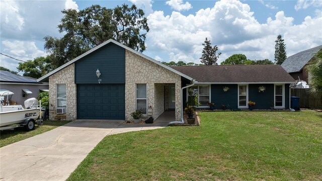 view of front of property featuring a front lawn and a garage