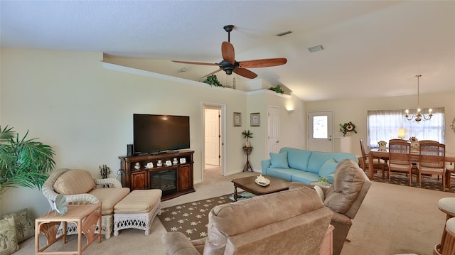 living room with carpet floors, ceiling fan with notable chandelier, lofted ceiling, and ornamental molding