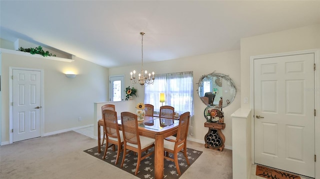 carpeted dining space featuring an inviting chandelier and lofted ceiling