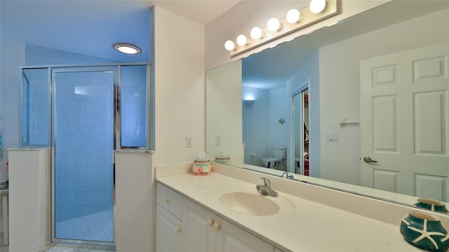 bathroom featuring toilet, tiled shower, and vanity