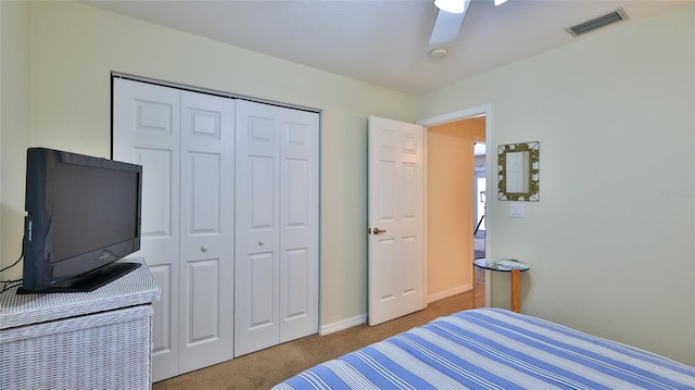 bedroom featuring ceiling fan, carpet, and a closet