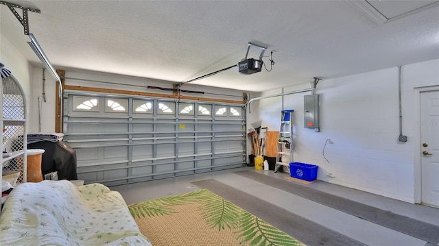 garage with a garage door opener and electric panel