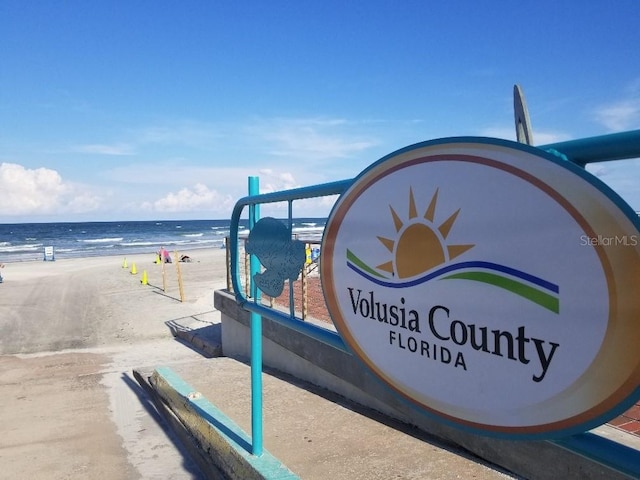 exterior space featuring a water view and a view of the beach