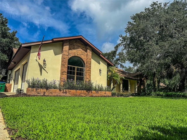 view of home's exterior with a lawn and a garage