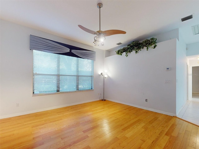 unfurnished room featuring light hardwood / wood-style floors and ceiling fan