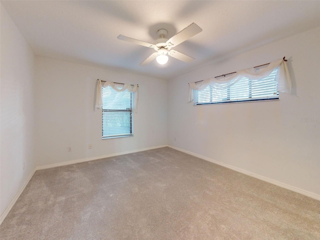 unfurnished room with light carpet and ceiling fan