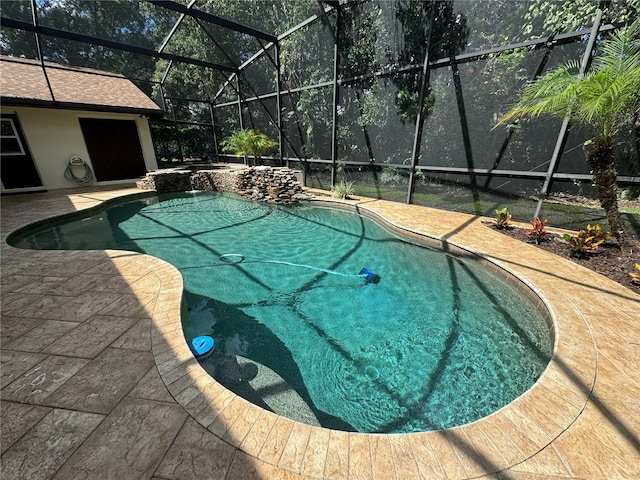 view of swimming pool featuring a patio and glass enclosure