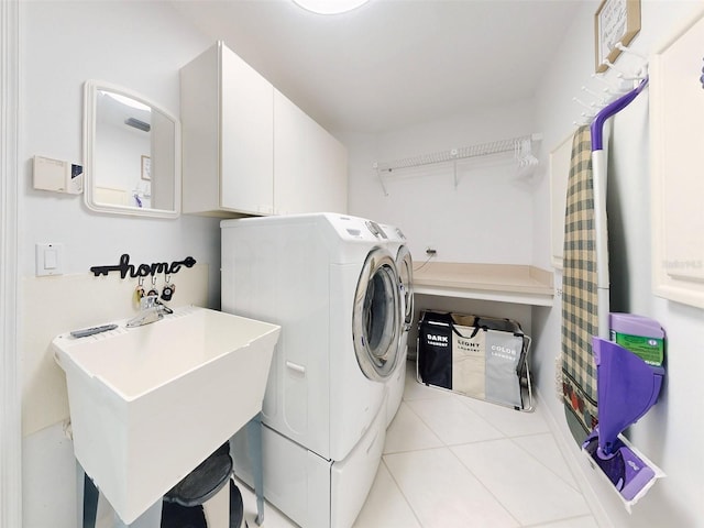 washroom with independent washer and dryer, cabinets, light tile patterned floors, and sink