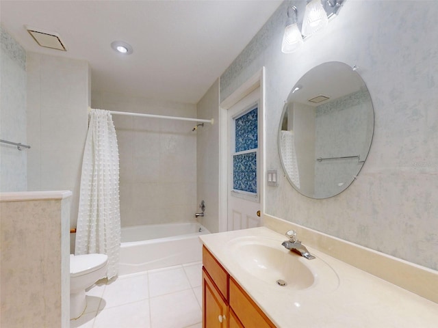 full bathroom featuring tile patterned floors, shower / bath combo with shower curtain, vanity, and toilet