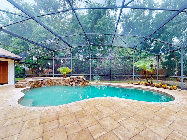 view of pool with a lanai and a patio